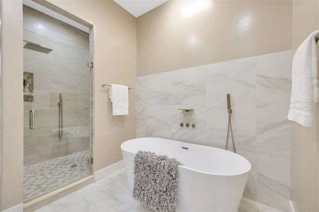 bathroom with separate shower and tub