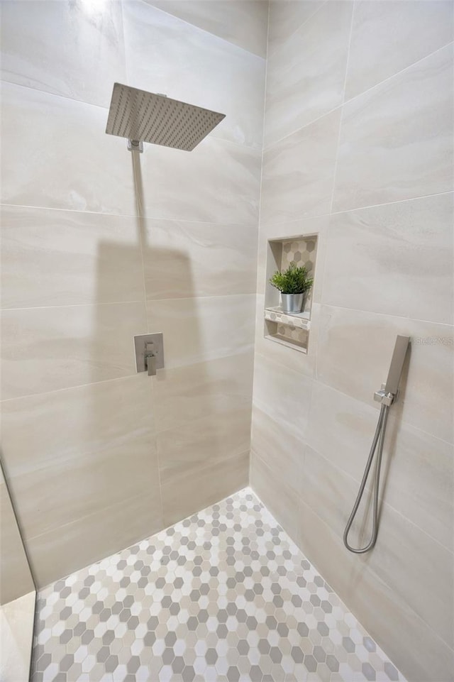 bathroom with tiled shower