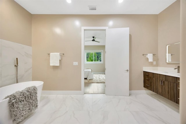 bathroom featuring ceiling fan, vanity, and a tub