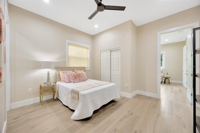 bedroom with light hardwood / wood-style flooring, a closet, and ceiling fan