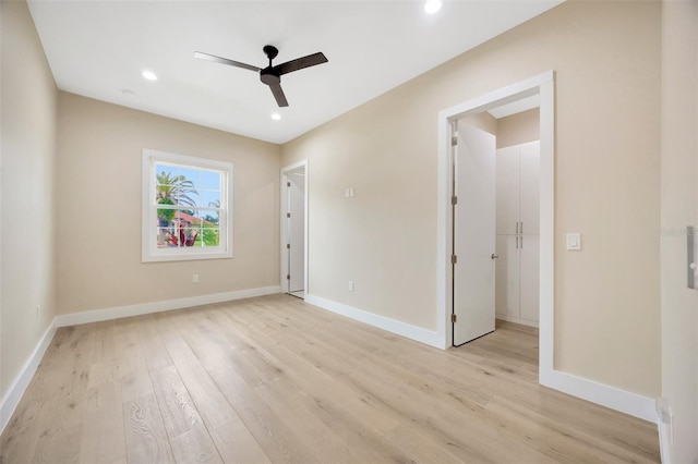 unfurnished room with ceiling fan and light wood-type flooring