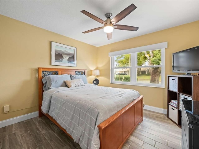 bedroom with ceiling fan and light wood-type flooring