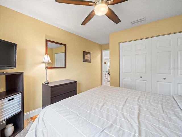 bedroom featuring a closet, ceiling fan, and light wood-type flooring