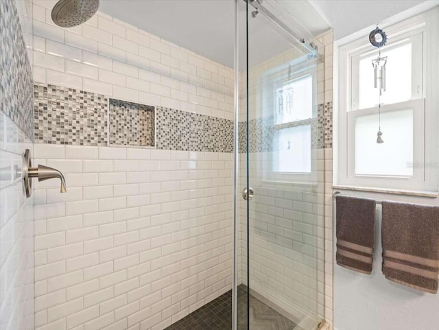 bathroom with a shower with door