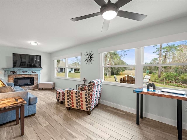 living room featuring ceiling fan and light wood-type flooring