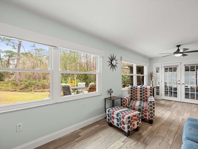 sunroom / solarium with french doors and ceiling fan