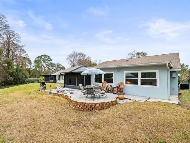 rear view of house with a sunroom, a yard, central AC, and a patio area