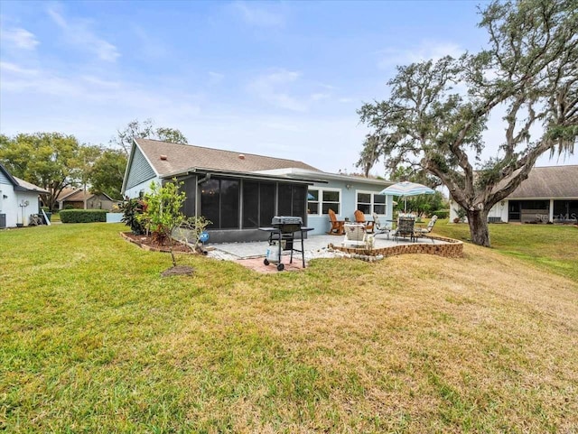 back of property with a patio area, a sunroom, and a lawn