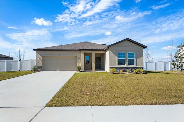 view of front of property featuring a garage and a front lawn