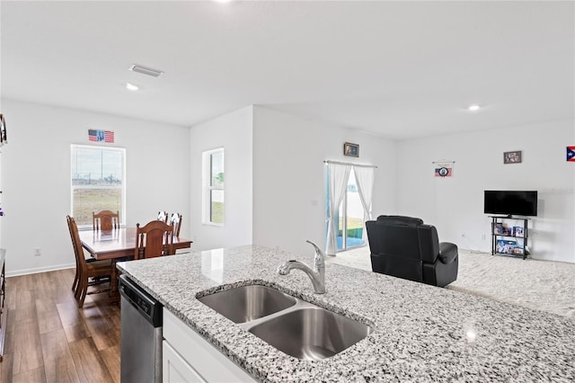 kitchen featuring sink, white cabinetry, dark hardwood / wood-style flooring, dishwasher, and light stone countertops