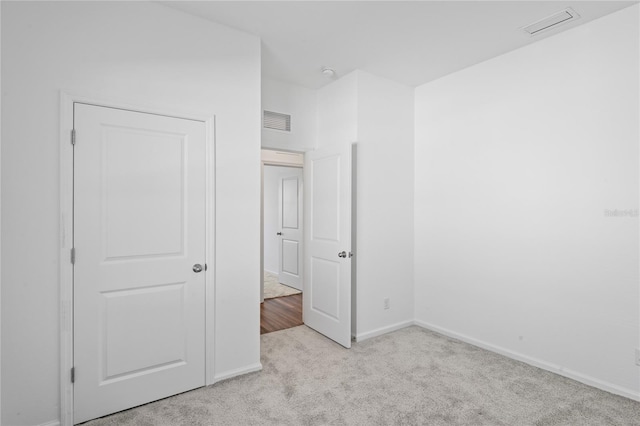 unfurnished bedroom with light carpet