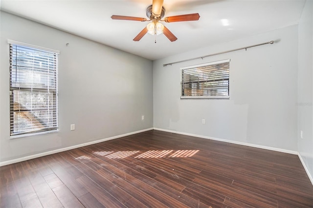 empty room featuring ceiling fan and dark hardwood / wood-style floors