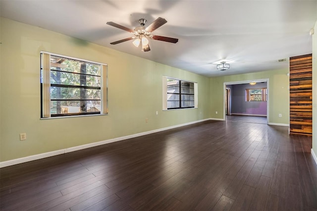 unfurnished room with dark wood-type flooring and ceiling fan