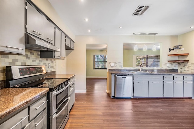 kitchen with dark hardwood / wood-style flooring, sink, decorative light fixtures, and appliances with stainless steel finishes