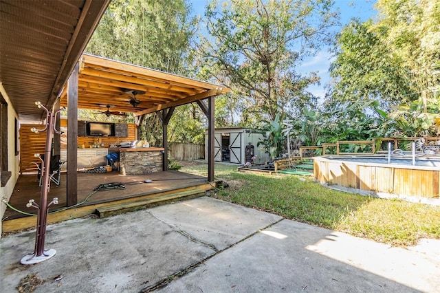 view of patio featuring area for grilling, a swimming pool side deck, ceiling fan, and a storage unit