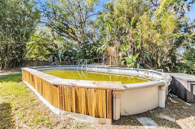 view of pool with a jacuzzi