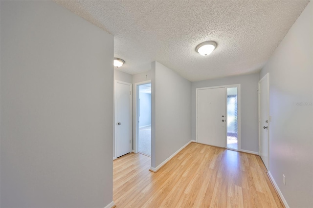 entryway featuring a textured ceiling and light wood-type flooring