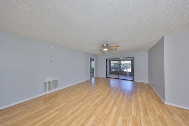 spare room featuring ceiling fan, a textured ceiling, and light wood-type flooring