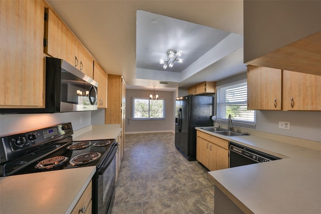 kitchen with black appliances, sink, a notable chandelier, a tray ceiling, and light brown cabinets