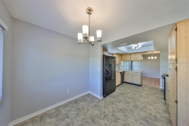 kitchen featuring a chandelier, a textured ceiling, light brown cabinets, hanging light fixtures, and black appliances