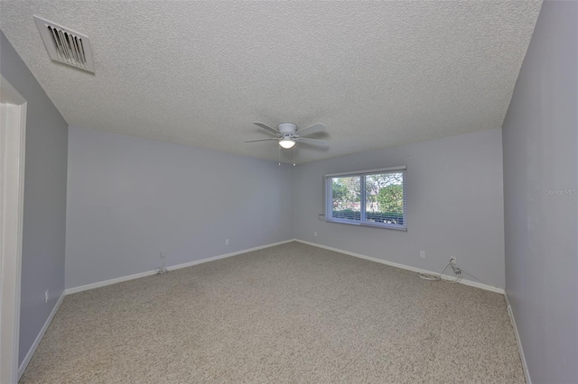 carpeted empty room featuring a textured ceiling and ceiling fan