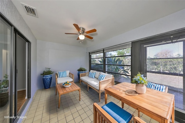 sunroom with ceiling fan