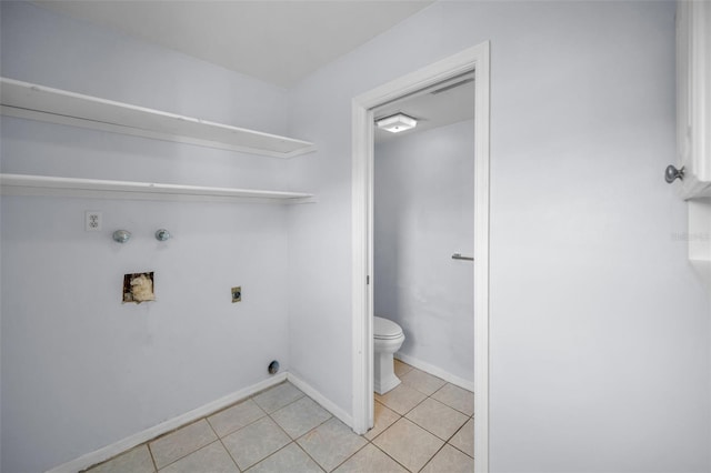 clothes washing area with gas dryer hookup, washer hookup, light tile patterned floors, and electric dryer hookup