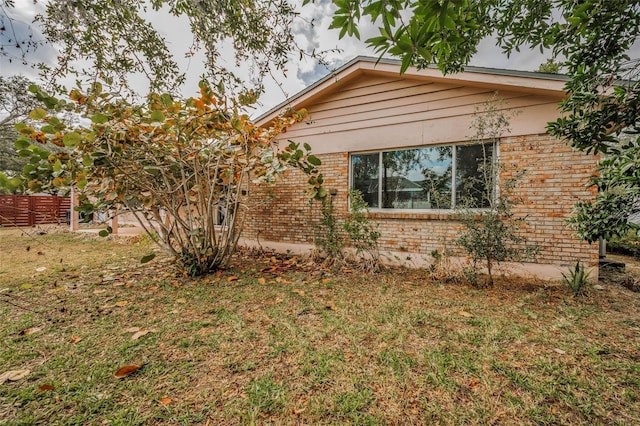 view of side of home featuring a yard