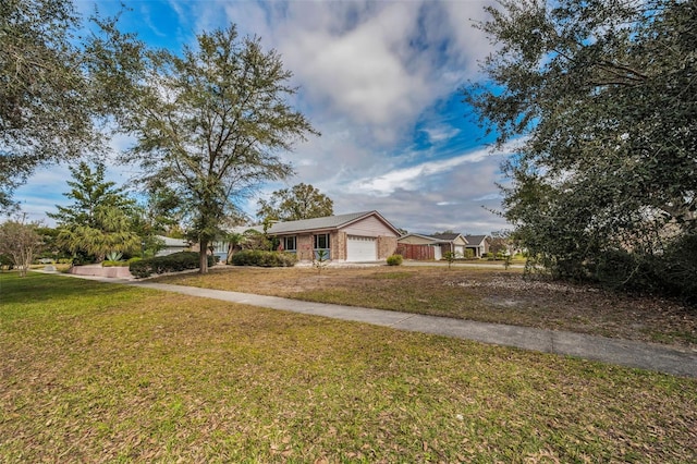 view of front of house with a garage and a front lawn