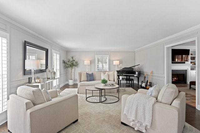 living room with crown molding, hardwood / wood-style flooring, and a wealth of natural light