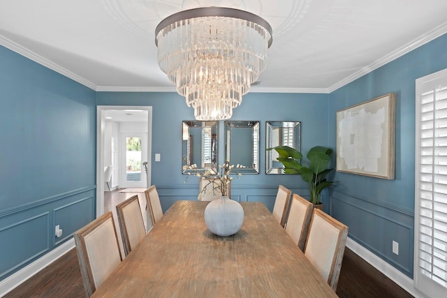 dining space with an inviting chandelier, ornamental molding, and dark hardwood / wood-style floors