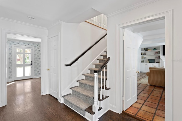 staircase with ornamental molding and wood-type flooring