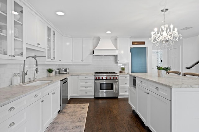 kitchen featuring custom exhaust hood, white cabinetry, appliances with stainless steel finishes, and sink