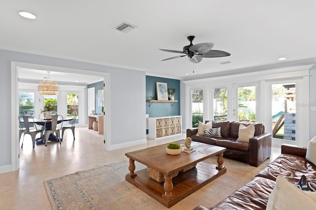 tiled living room with crown molding and ceiling fan with notable chandelier