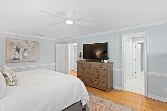 bedroom with wood-type flooring, ornamental molding, and ceiling fan