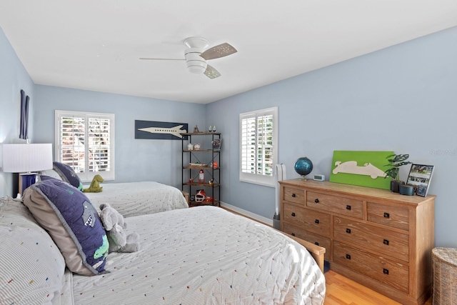 bedroom with ceiling fan and light hardwood / wood-style flooring