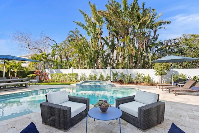 view of pool featuring a patio and an in ground hot tub