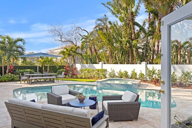 view of swimming pool with an outdoor living space, an in ground hot tub, and a patio area