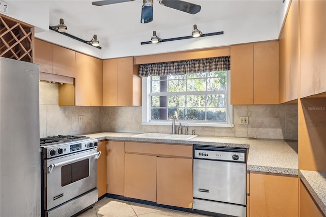 kitchen with tasteful backsplash, sink, light tile patterned floors, and stainless steel appliances