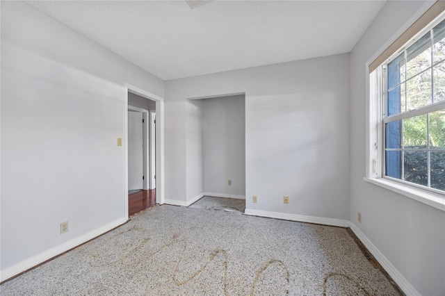 empty room featuring a textured ceiling