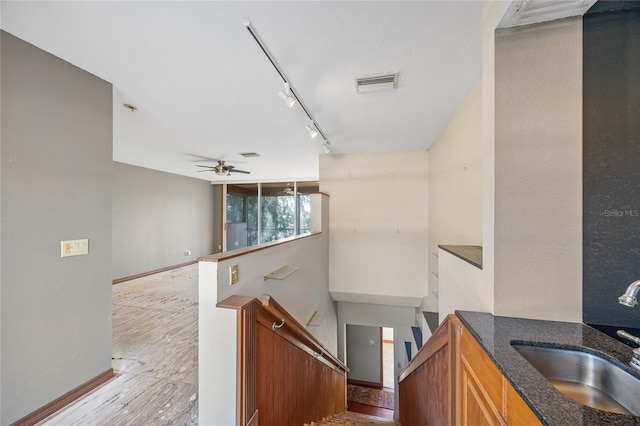 interior space featuring ceiling fan, track lighting, and sink