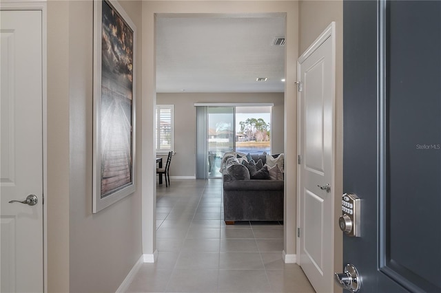 hall featuring light tile patterned floors