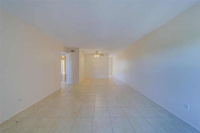 spare room featuring light tile patterned floors and ceiling fan