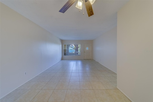 spare room with light tile patterned flooring and ceiling fan