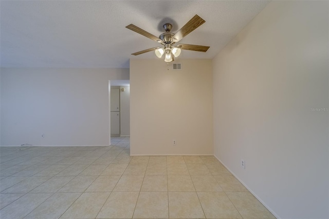 tiled empty room with a textured ceiling and ceiling fan