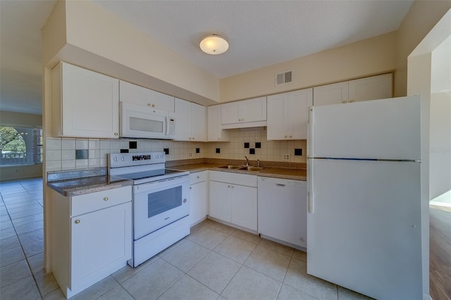 kitchen featuring tasteful backsplash, sink, white appliances, and white cabinets