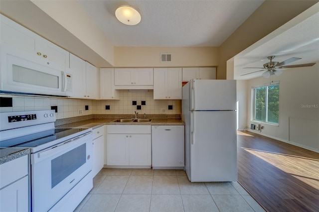 kitchen with white cabinetry, white appliances, and sink