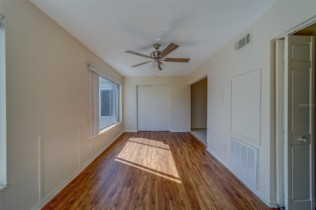 spare room featuring dark hardwood / wood-style floors and ceiling fan