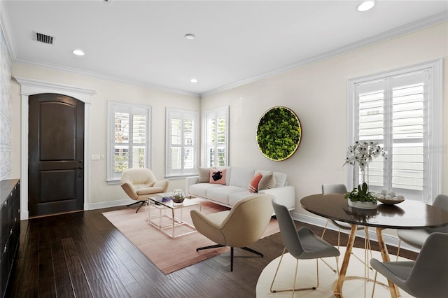 living room with crown molding and dark wood-type flooring