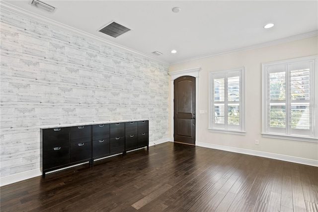 spare room with dark hardwood / wood-style flooring and ornamental molding